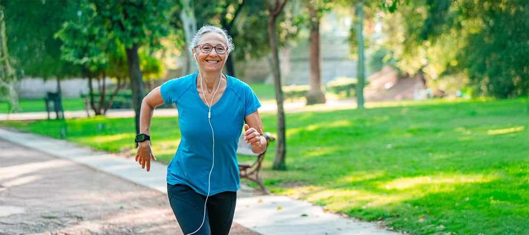 Smiling senior woman exercising outdoors.