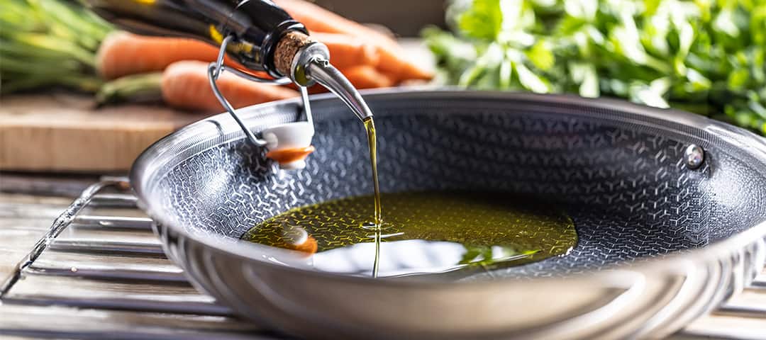 Healthy olive oil with polyphenols poured into a pan