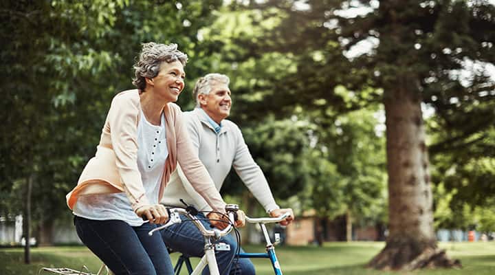 Mature couple riding a bike