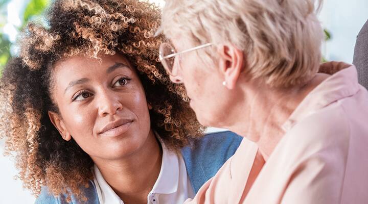 nurse taking care of an older lady with alzheimers disease