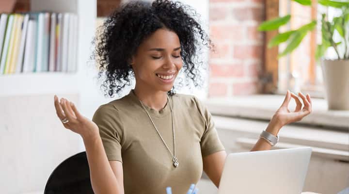 Woman with a calm mind in front of a loptop