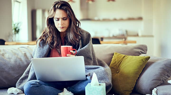 Sick woman on couch needs help from her immune system