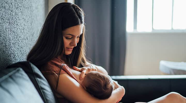 Woman breastfeeding her baby to provides natural immunity