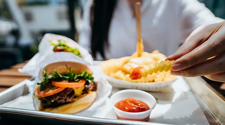 Fries and hamburger that contain amounts of saturated fats that should be minimized