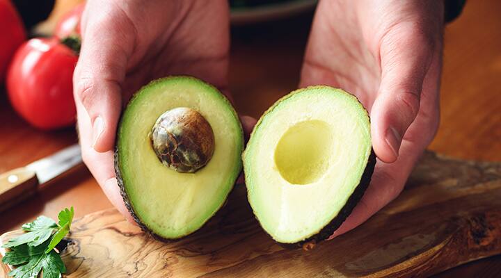 Opened avocado being displayed that has been kept at room temperature