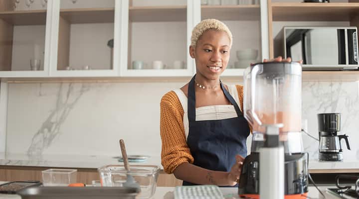 Young woman preparing healthy-option ginger slices with whole foods