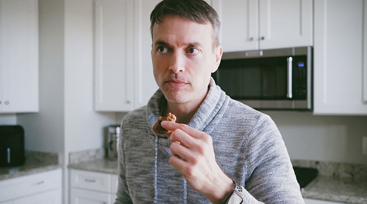 Man eating a protein powder cooking after a workout to help recover after