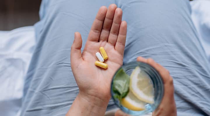 Woman taking vitamins and supplements.