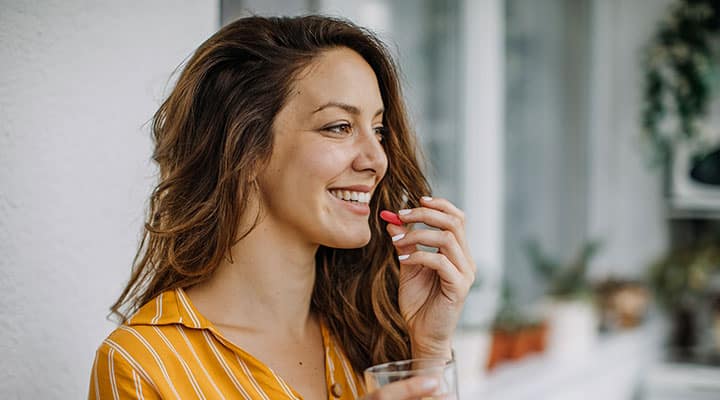Woman taking supplement