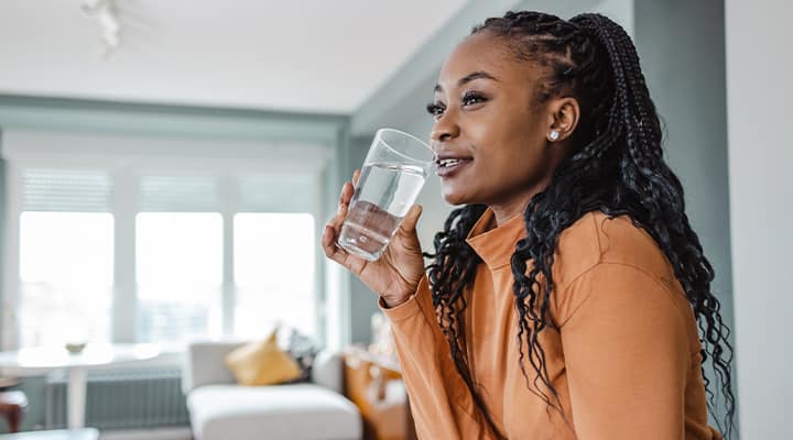Woman taking vitamin C for immune health.