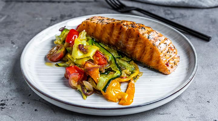 Fish and Mediterranean veggies on plate for dinner