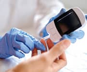 Doctor takes blood sugar test to see effects of curcumin