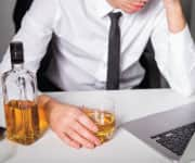 Man holding glass of alcohol