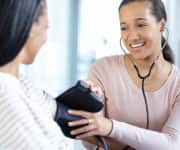 Woman measuring the blood preassure of another woman